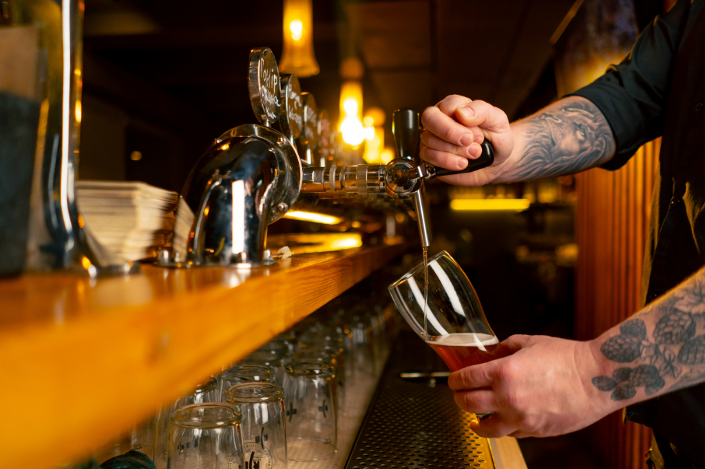 Photo of a beer being poured in a tap room